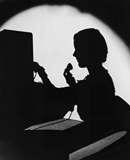 Retrofile Gallery: ARCHIVE SHOT / SILHOUETTE OF SWITCHBOARD OPERATOR / INDOORS