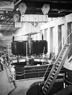 Prints of circa 1935: An 82, 500 kilovolt-ampere rotor is lowered into place on the Arizona wing of the Boulder Dam (now Hoover Dam) during its construction. (Photo by Atlas/Getty Images) A Timeless Collection of Hoover Dam Photography: Arizona Wing