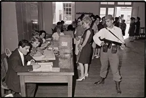 Armed Prints: Armed Guard Watches Voters Cast Ballots