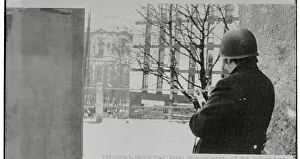 Armed Policeman Gazing at Building Where Hostages are Held