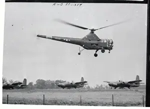 Army Helicopter Hovering Over Waiting Planes