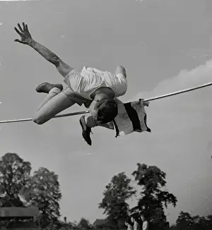Art Jackes Straddling High Bar During Jump