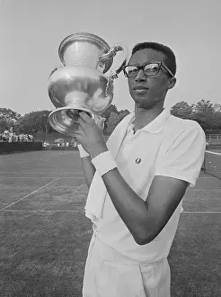 Tennis Court Prints: Arthur Ashe Holding Trophy