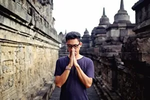 Images Dated 29th February 2016: Asian man in blue tshirt at Borobudur temple