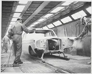Assembly Line Men Spraying Off Car