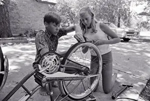 Astronaut Buzz Aldrin's Children Working on Bicycle