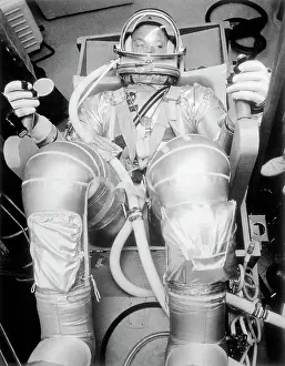 Astronaut L Gordon Cooper Sitting in Space Suit