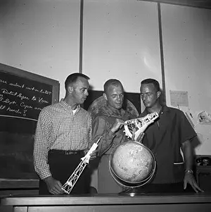 Astronauts Holding Rocket Models