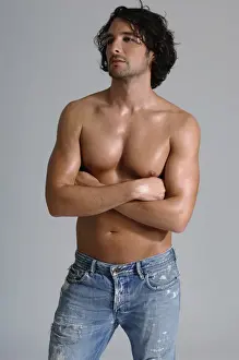 Athletic man, early 30s, bare-chested wearing jeans