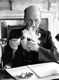 Prints of English Labour statesman and prime minister Clement Richard Attlee, (1883 - 1967), 1st Earl Attlee, smoking in his office A Quiet Strength: A Leader Who Shaped Modern Britain: Attlee Smoking