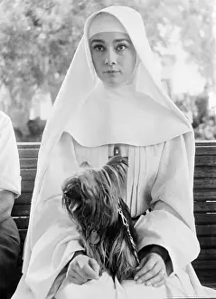 Habit Prints: Audrey Hepburn in Costume Holding Her Dog