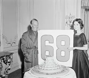 Audrey Hepburn Holding a Sign with Maurice Chevalier