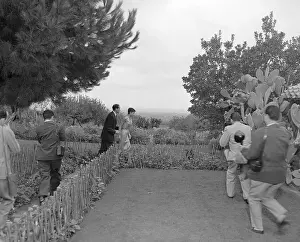 Audrey Hepburn and Mel Ferrer Running From Photographers