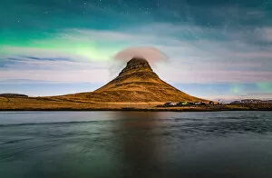 Images Dated 24th March 2016: Aurora borealis and cloud cap over the Kirkjufell mountain the iconic landmark of west Iceland