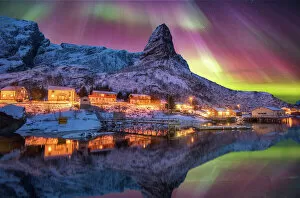 Northern Lights Collection: Aurora borealis above snowy islands of Lofoten