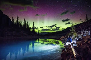Northern Lights: A Dance of Colours Collection: The aurora borealis above the turquoise waters of Moraine Lake, Banff National Park, Alberta, Canada