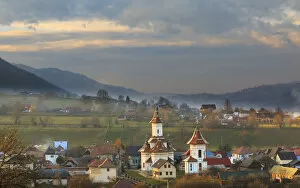 Images Dated 7th November 2015: Autumn landscape of village and mountain range in background, Campulung Moldovenesc