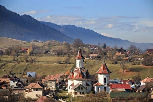 Images Dated 7th November 2015: Autumn landscape of village and mountain range in background, Campulung Moldovenesc