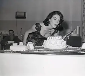 Ava Gardner Blowing out Candle on Birthday Cake
