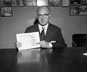 Avery Brundage Holding a Newspaper