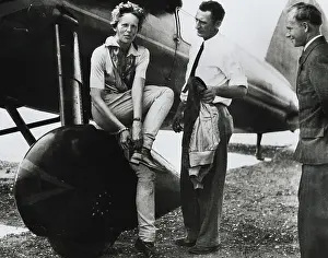 Aviatrix Amelia Earhart Adjusting Her Shoes After Successful Flight