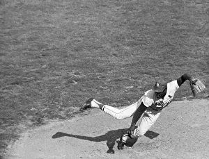 Pitching Prints: B. Gibson Falls As He Follows Pitch Thru