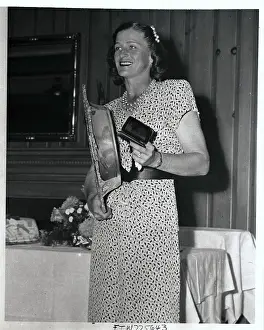 Babe Didrikson Holding Trophies