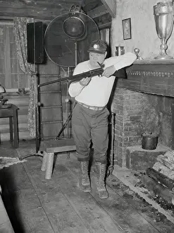 Babe Ruth Holding a Rifle on Set
