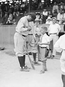 Autographing Prints: Babe Ruth Signs Baseball For Child Fan