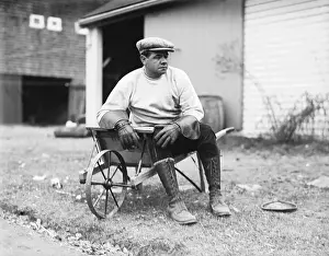 Babe Ruth Sitting on Wheelbarrow