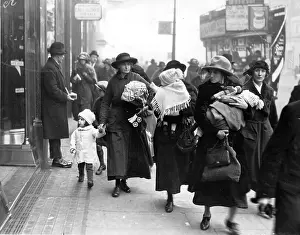 Prints of circa 1922: Women carrying babies and Christmas shopping. (Photo by Hulton Archive/Getty Images) Celebrate the Season: A Curated Collection of Christmas Art: Babies And Bargains