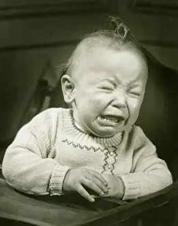 Baby (9-12 months) in baby seat crying, (B&W), close-up