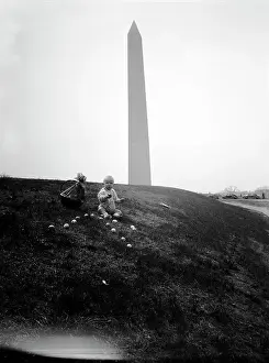 Celebration Event Prints: Baby boy (6-11 months) sitting by Washington Monument with Easter eggs