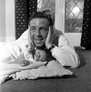 Prints of 30th January 1954: British slapstick comedian, Norman Wisdom, joking with his baby son, Nicholas Master of Mime, Icon of Cinema: Chaplin in Prints: Baby Joke
