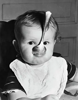 Baby with Spoon in Mouth