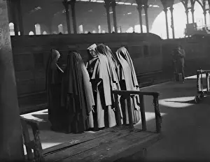 Prints of 19th May 1932: A huddle of nuns waiting at Liverpool Street station, London to board a special train taking about 400 of them to a Roman Catholic schools conference. (Photo by Fox Photos/Getty Images) Timeless Treasures: Iconic Black and White Prints from the Fox Photo Library: Backs To The World