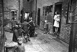 Prints of Children playing in a backyard slum in Coventry, 1942. (Photo by Haywood Magee/Picture Post/Hulton Archive/Getty Images) Discover the Vision of Haywood Magee – A Master of Mid-Century British Life: Backyard Scramble