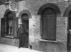 Prints of circa 1900: A youth standing outside C Middleburgs sacks and bags shop in Londons Limehouse. (Photo by Keystone/Getty Images) The Keystone Press Agency Collection Prints: Bag Man