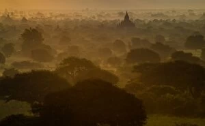 Images Dated 7th December 2014: Bagan pagodas in the mist during sunrise