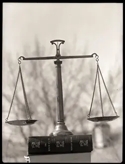 Weighing Prints: Balance Scales Perched On Book
