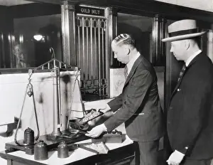 Banker Using Scale to Weigh Gold