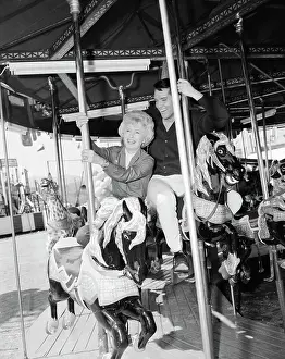 Barbara Stanwyck and Elvis Presley on a Carousel