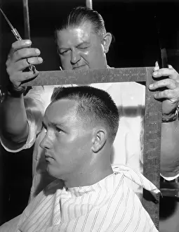 Barber Using Carpenter's Square on Customer