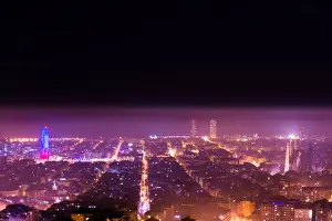 Eyesight Prints: Barcelona cityscape with Sagrada Familia and Agbar tower illuminated at night between spring fog