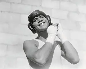 Barney Ross Adjusting His Head Gear