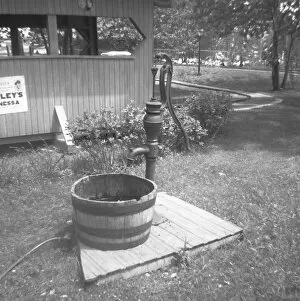 Barrel at water pump in garden, (B&W)