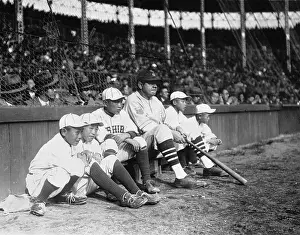 Baseball Bat Boys Sitting on Sidelines