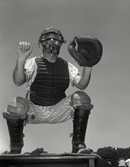 Action Prints: A baseball catcher on top of table with fist up