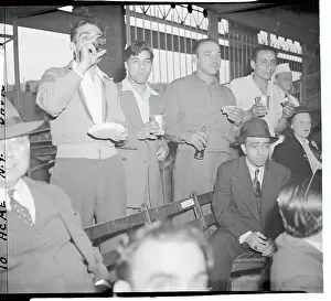 Baseball Fans Standing Having Hot Dogs and Cokes