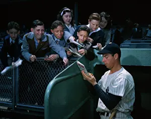 Autographing Prints: Baseball Legend Joe DiMaggio Signing Autographs for Youngsters